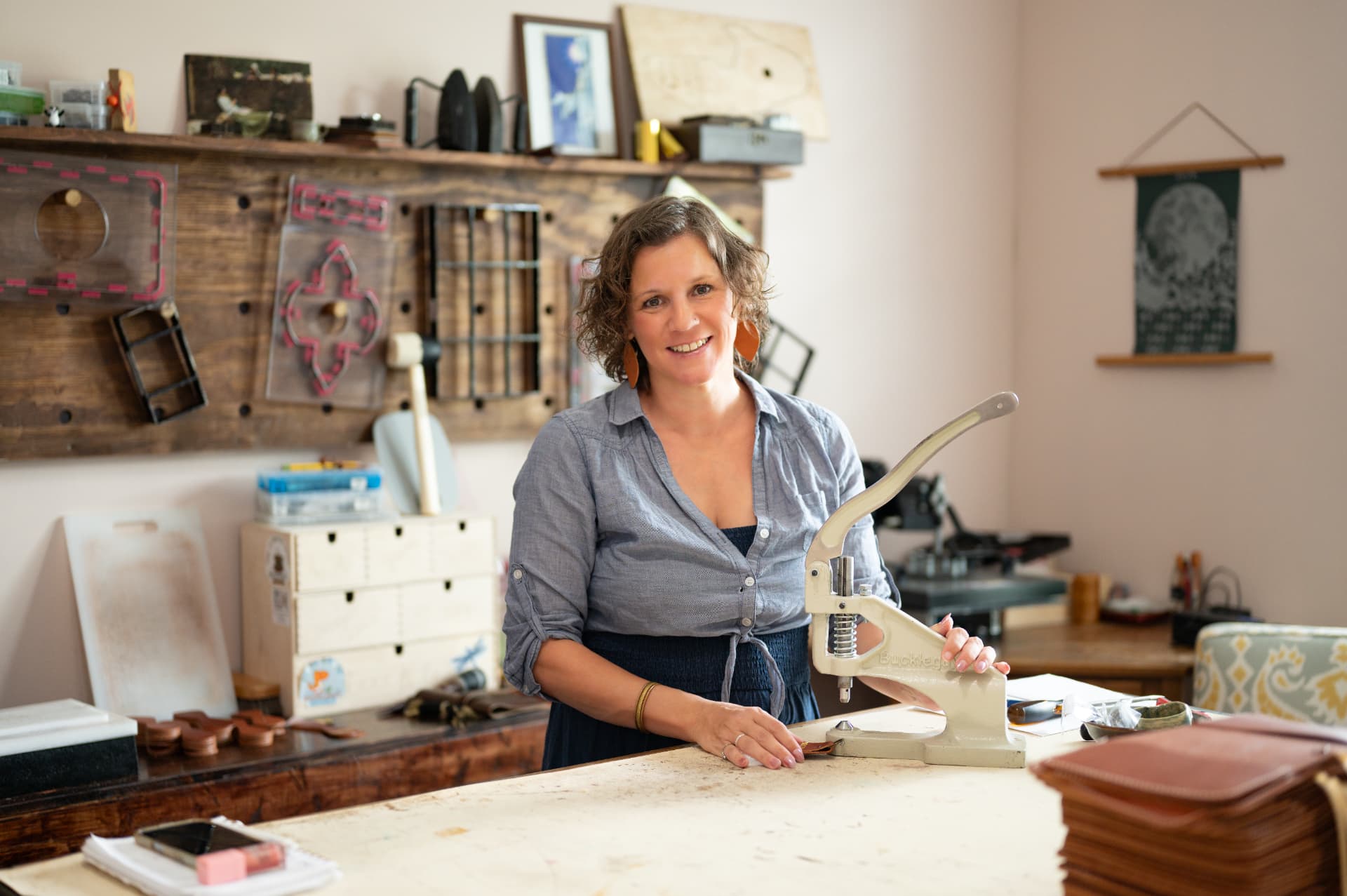 Sarah smiling at her bench, hand press in the foreground