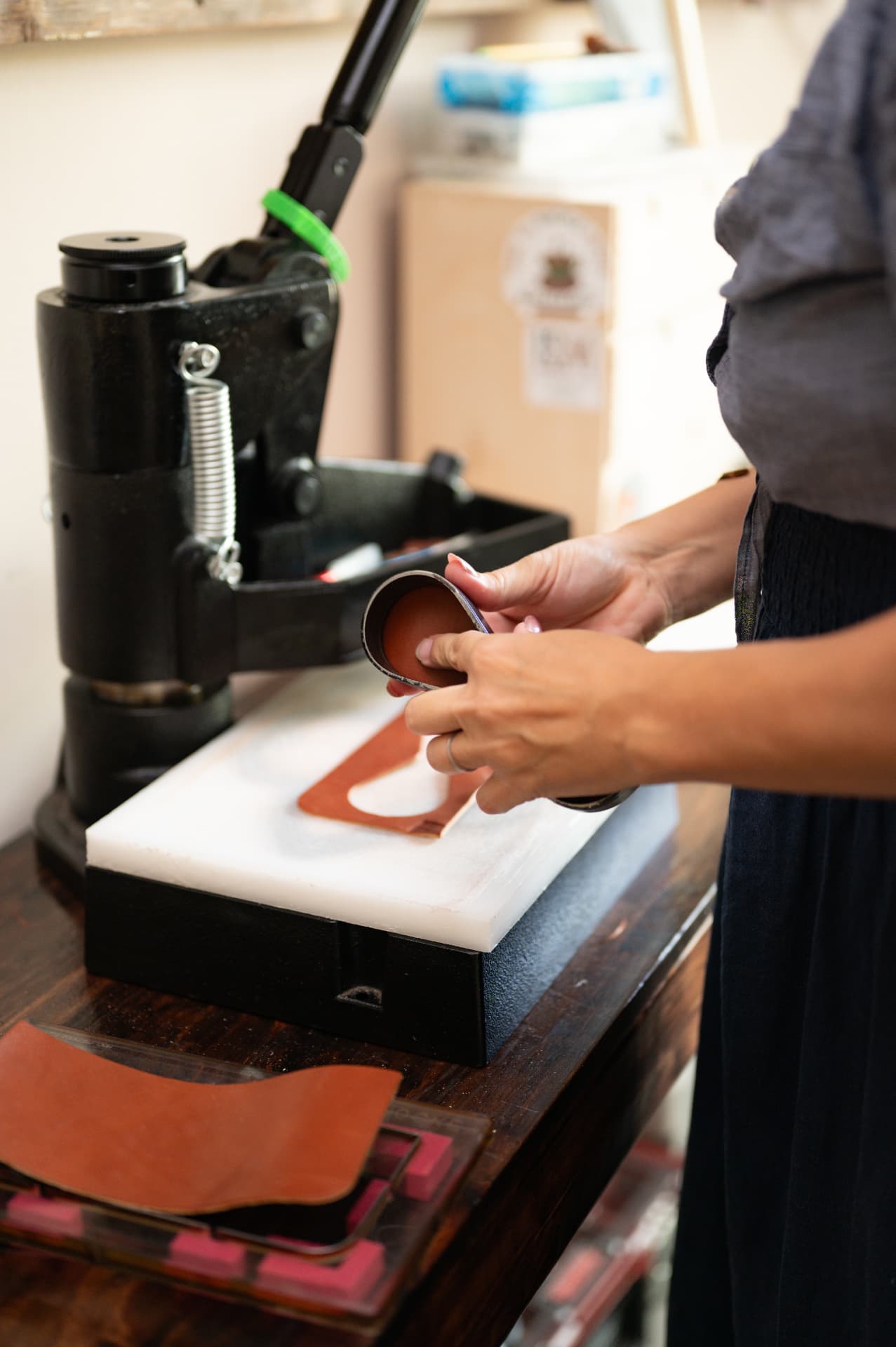 Hands finishing a piece near the press